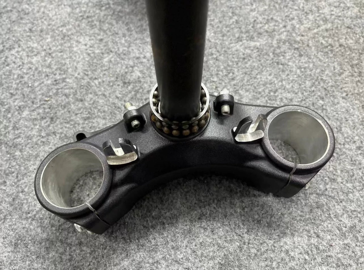 Ducati Monster 821 handlebar bracket mount detail, showing clamp holes and machined aluminum finish