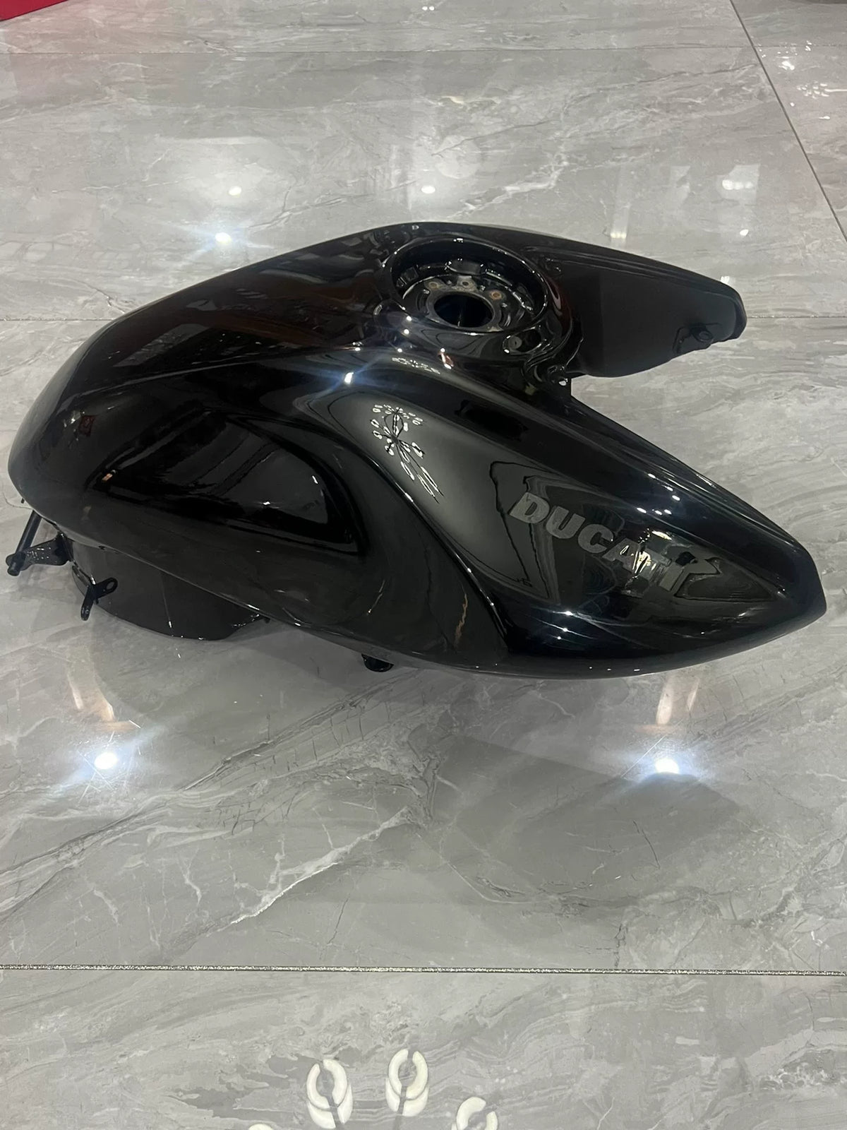 Ducati Diavel V4 black fuel tank side profile displaying smooth finish and mounting points