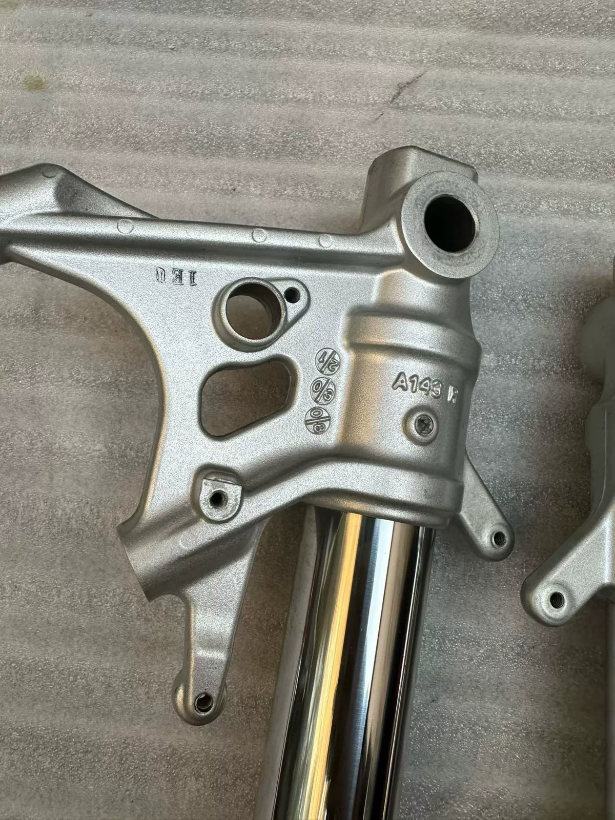 Aprilia Tuono 660 fork rods angled view showing straight shaft alignment and polished chrome surface