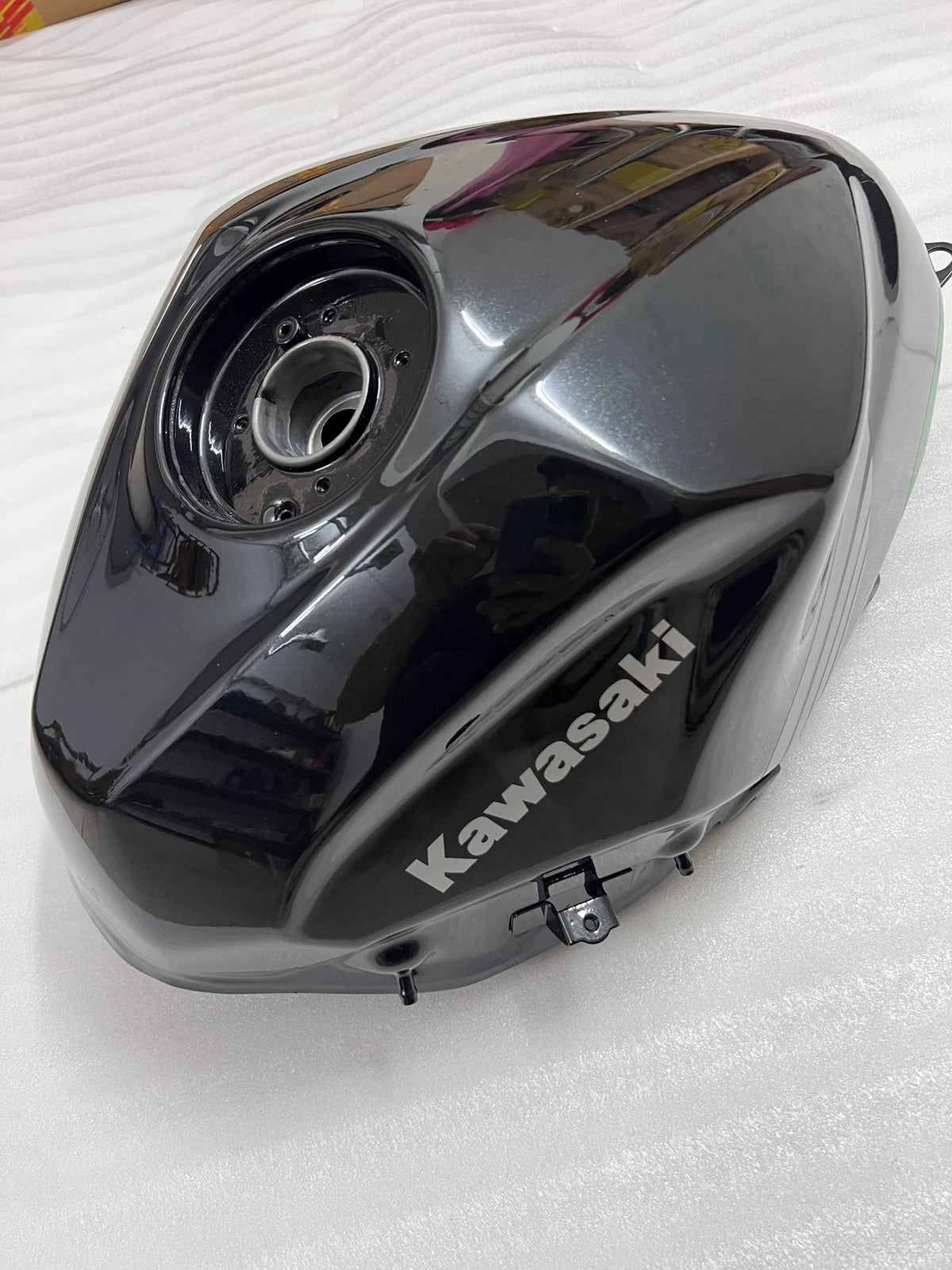 Kawasaki Ninja 400 fuel tank left side view showing tank shape and lower mounting tab detail
