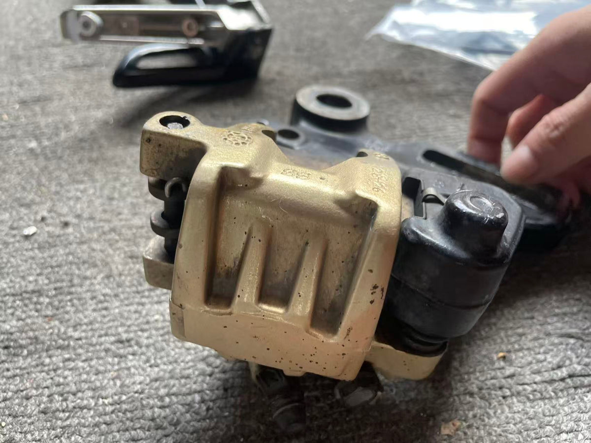 BMW G 310 R brake caliper rear angle showing mounting holes and caliper frame structure