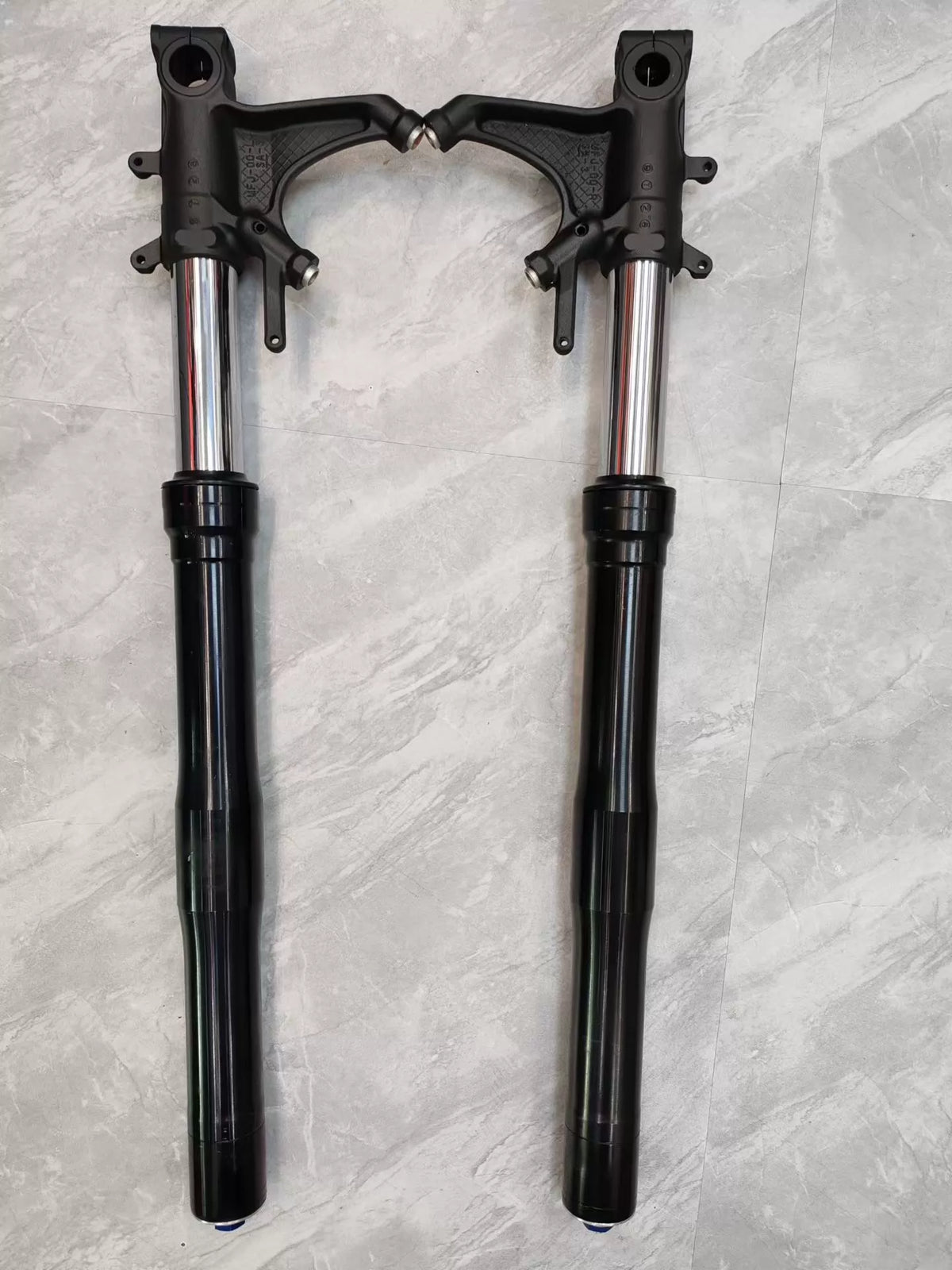 Close-up detail of CBR 600RR fork leg lower slider, axle clamp and brake caliper mount visible