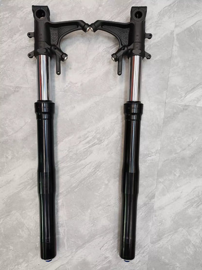 Close-up detail of CBR 600RR fork leg lower slider, axle clamp and brake caliper mount visible