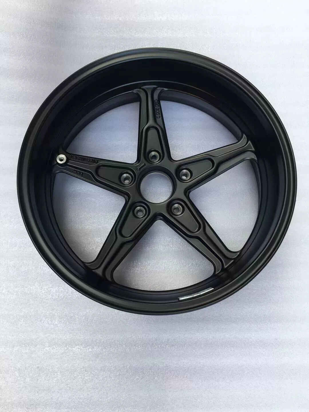 BMW R nineT rear cast rim, angled view highlighting hub center and casting detail