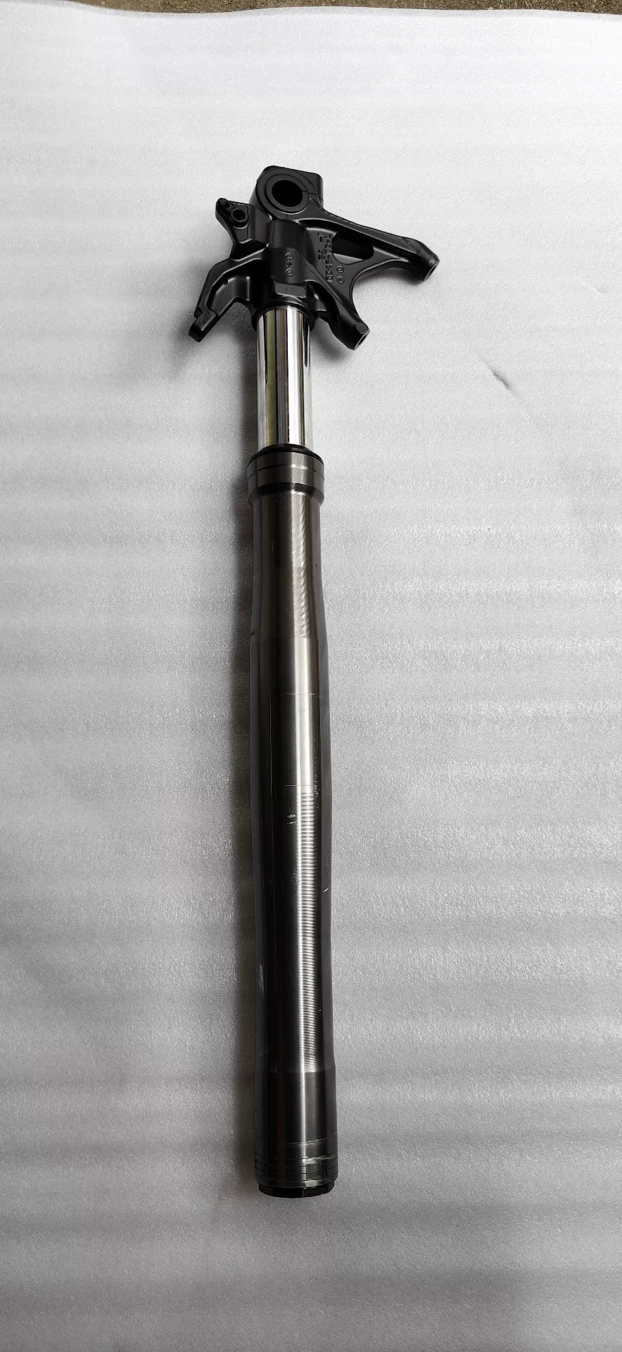 Ducati Panigale V2 front fork, close-up of upper chrome tube and dust seal, surface detail visible