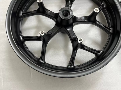 Honda NC750X front rim flat-on view displaying full spoke layout and valve hole, silver finish