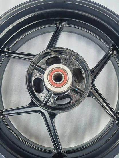 Rear wheel assembly gloss black Kawasaki Z800, three-quarter view displaying full rim width and construction