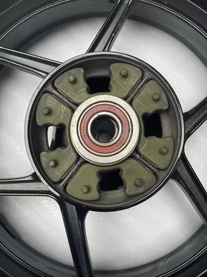 Kawasaki ZX-6R rear wheel rim WHEEL-ASSY gloss black, front-facing view highlighting center hub and bearings