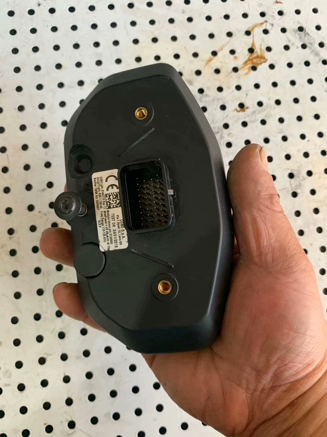Angled rear of Ducati Monster 797 gauge cluster, wiring connector and part-number label visible