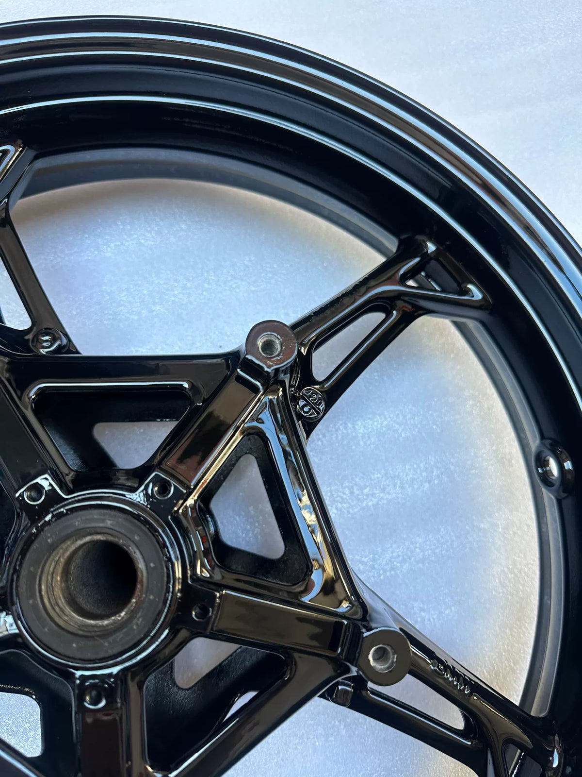 BMW S1000RR front wheel angled view highlighting five-spoke cast aluminum construction