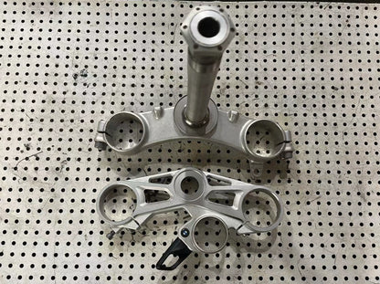 BMW S1000RR triple clamp side profile view showing fork tube clamps and precision CNC machining detail