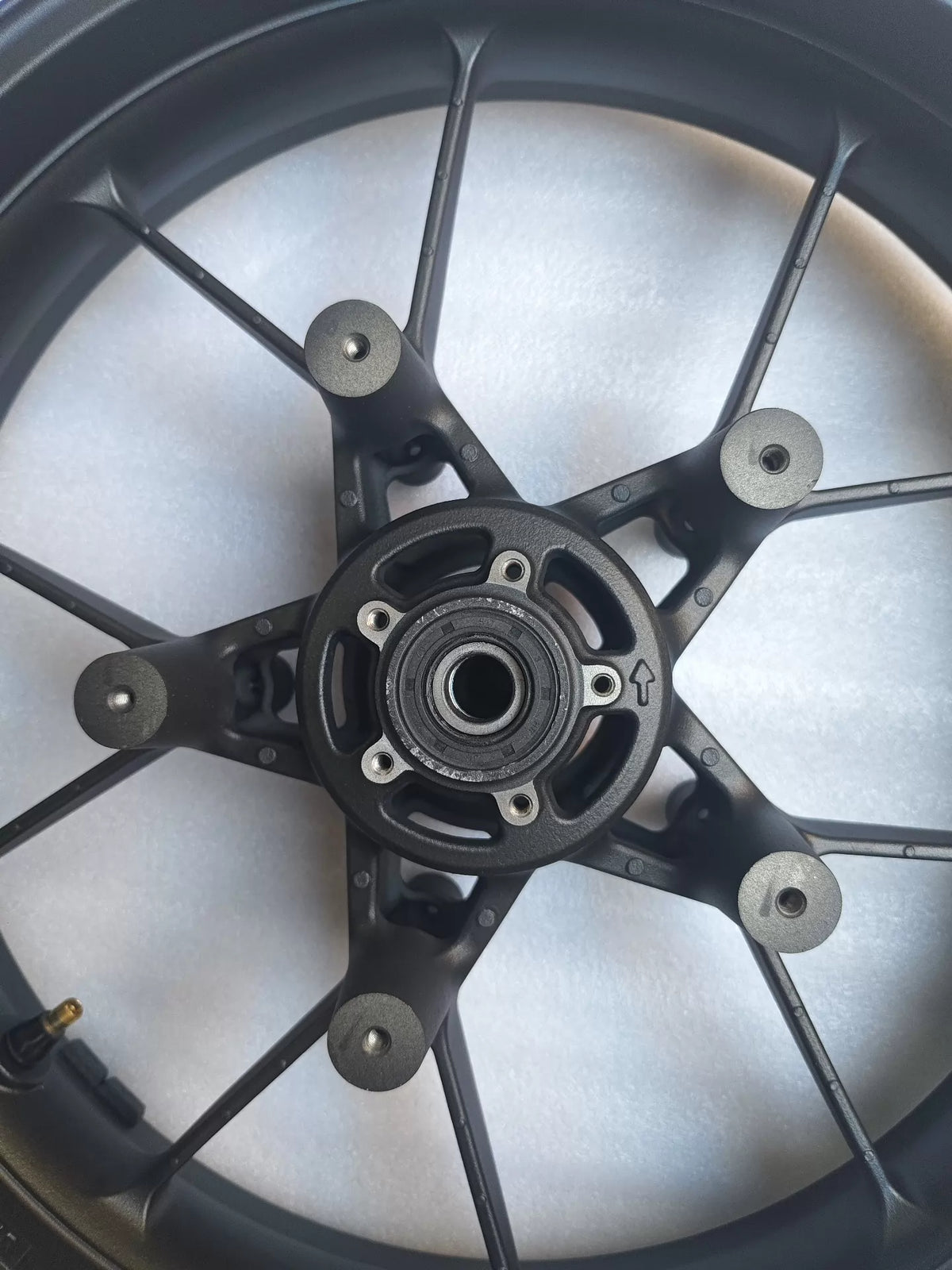 Honda CBR 500R front rim rear-facing view displaying disc rotor bolt pattern and axle bore detail