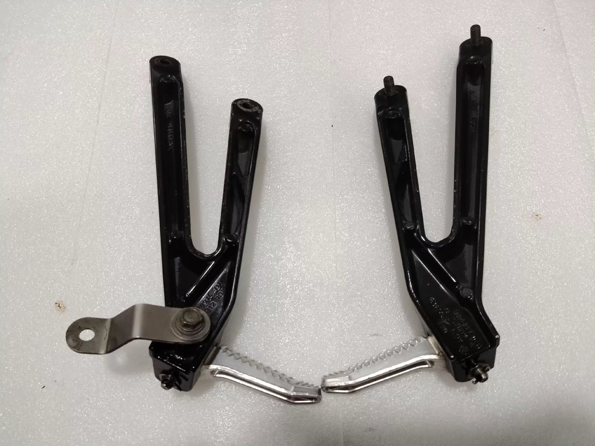 BMW S1000RR footpeg bracket, close-up of mounting hardware and threaded inserts detail