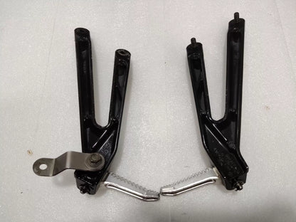 BMW S1000RR footpeg bracket, close-up of mounting hardware and threaded inserts detail