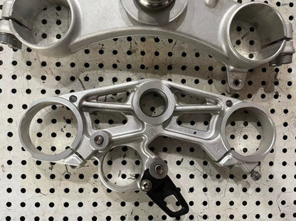 BMW S1000RR triple clamp close-up of stem and bearing race area showing hardware and finish quality
