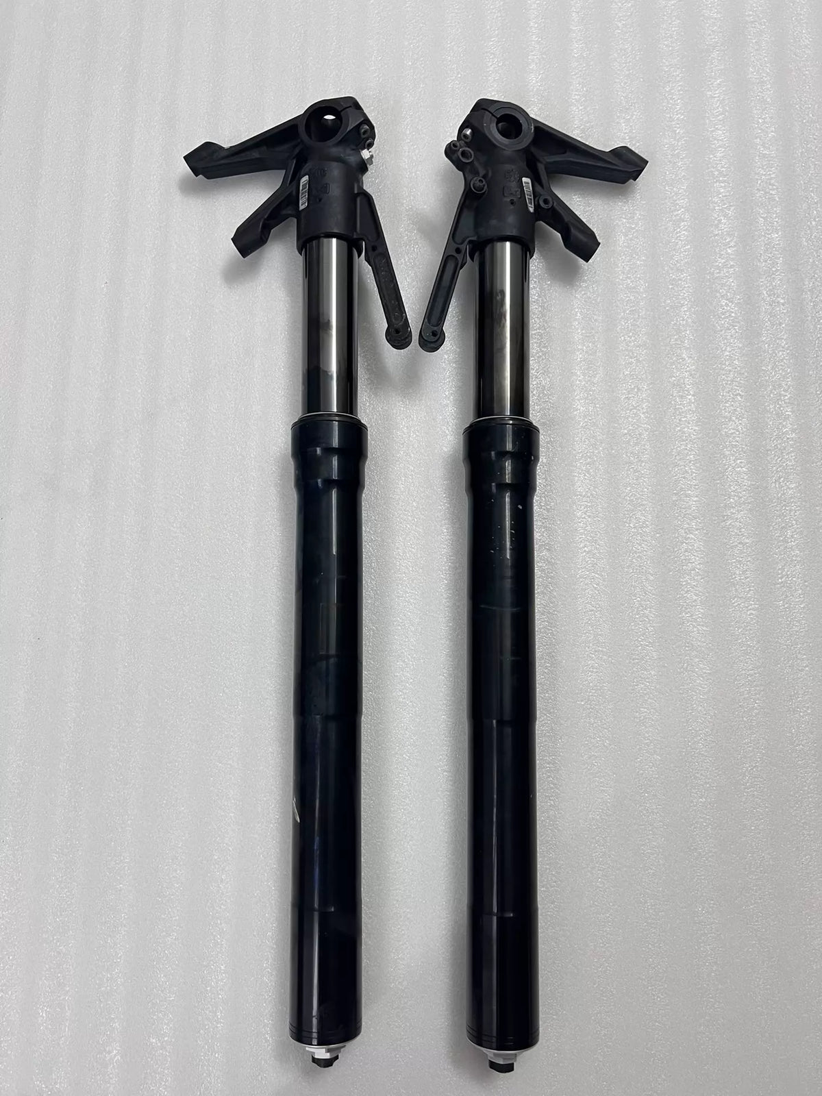Ducati Diavel 1200 front fork pair laid flat, overhead view showing full length of both fork legs