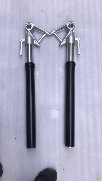 BMW S1000R fork leg left close-up showing brake caliper mount and axle pinch bolt bosses