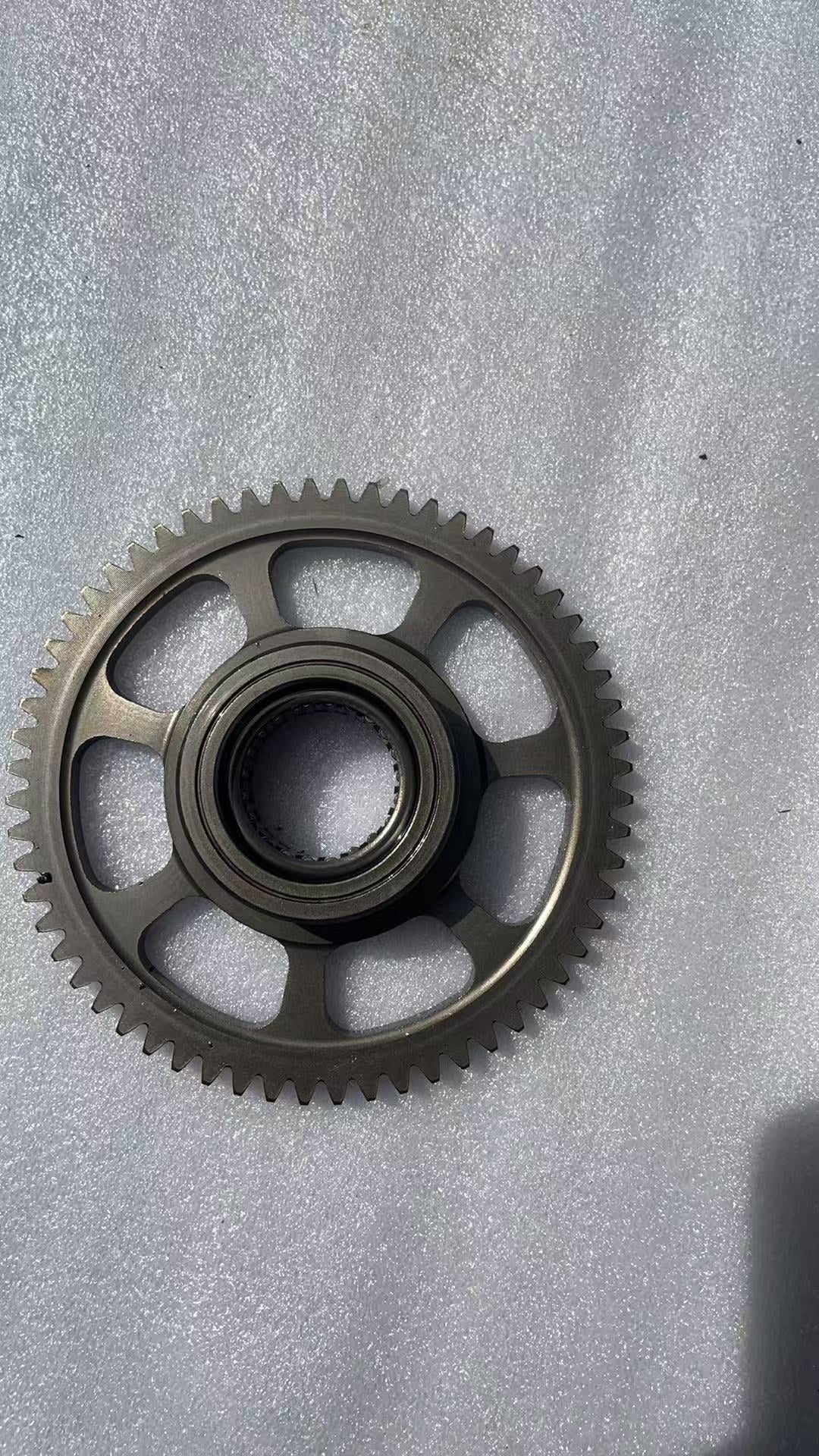 BMW G310R flywheel angled view showing overall shape and rotor construction