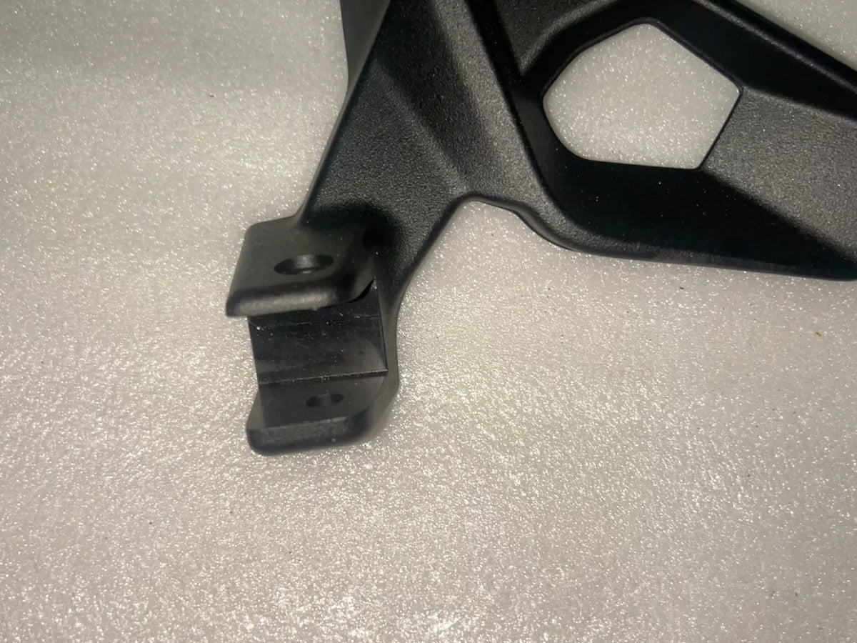 BMW S1000XR footpeg bracket, close-up of mounting plate and threaded hole positions