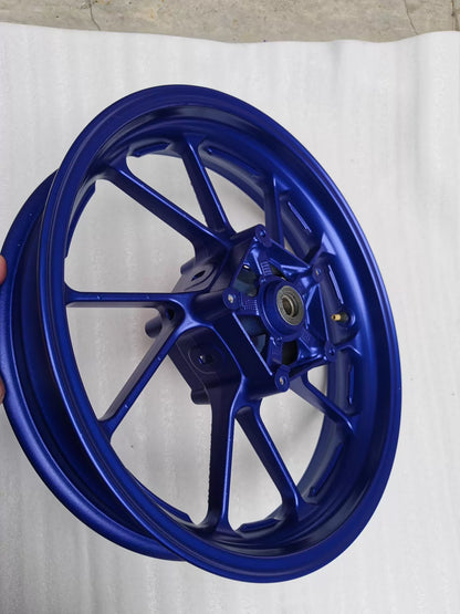 Three-quarter side view of blue cast front wheel for Yamaha MT-07 FZ-07, showing rim depth and spoke faces