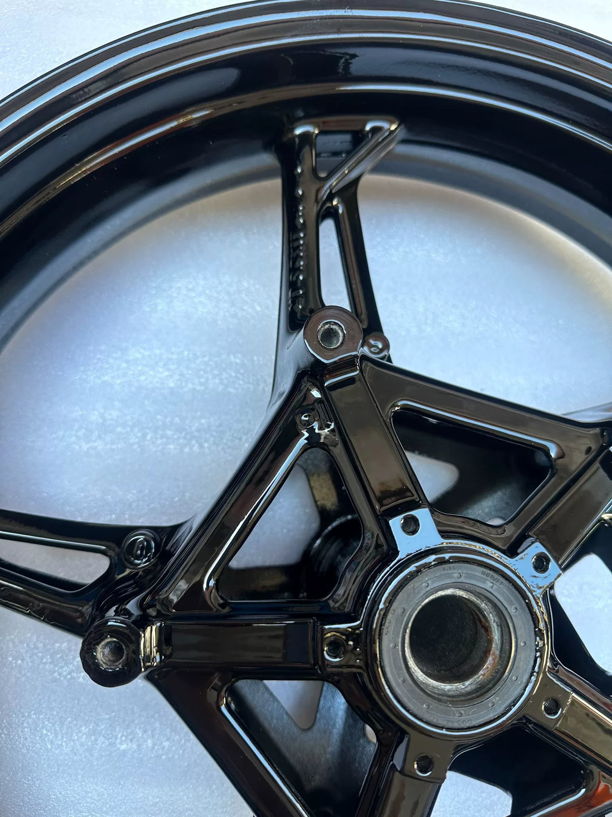 BMW S1000RR front wheel hub close-up showing bearing housing and axle bore detail