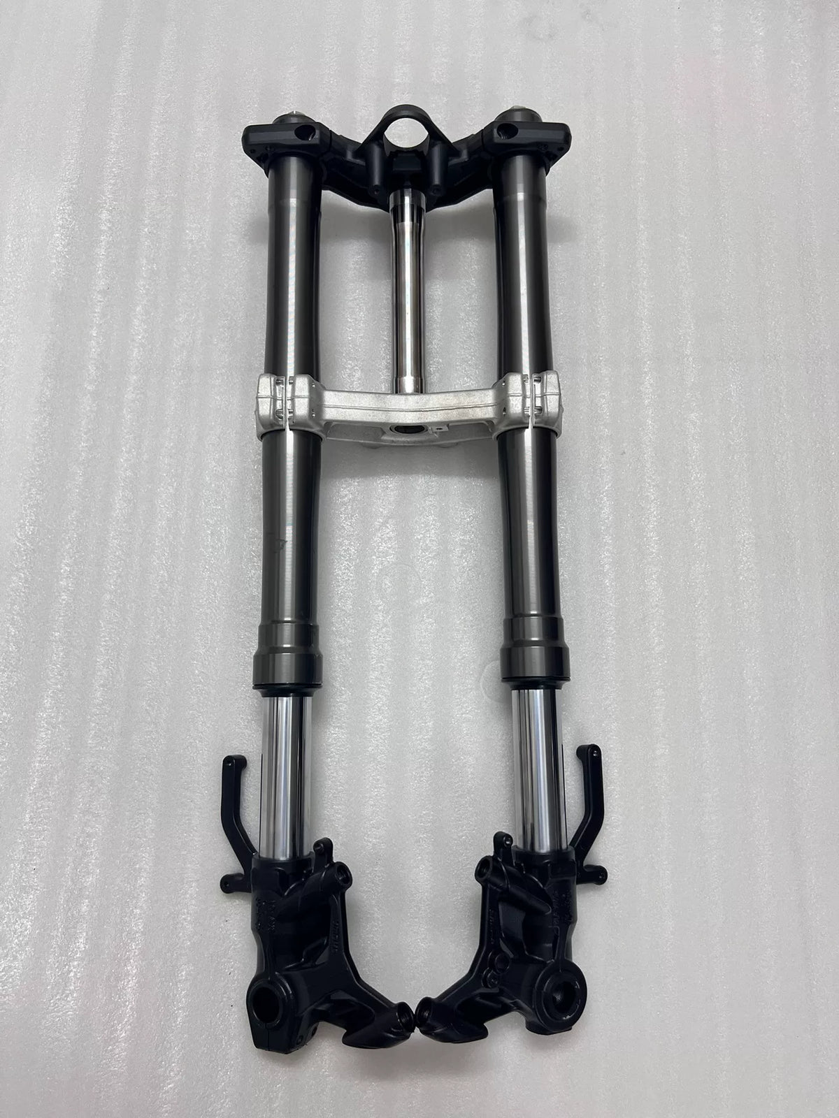 Ninja 1000SX front fork tubes close-up showing chrome stanchions and upper triple clamp detail