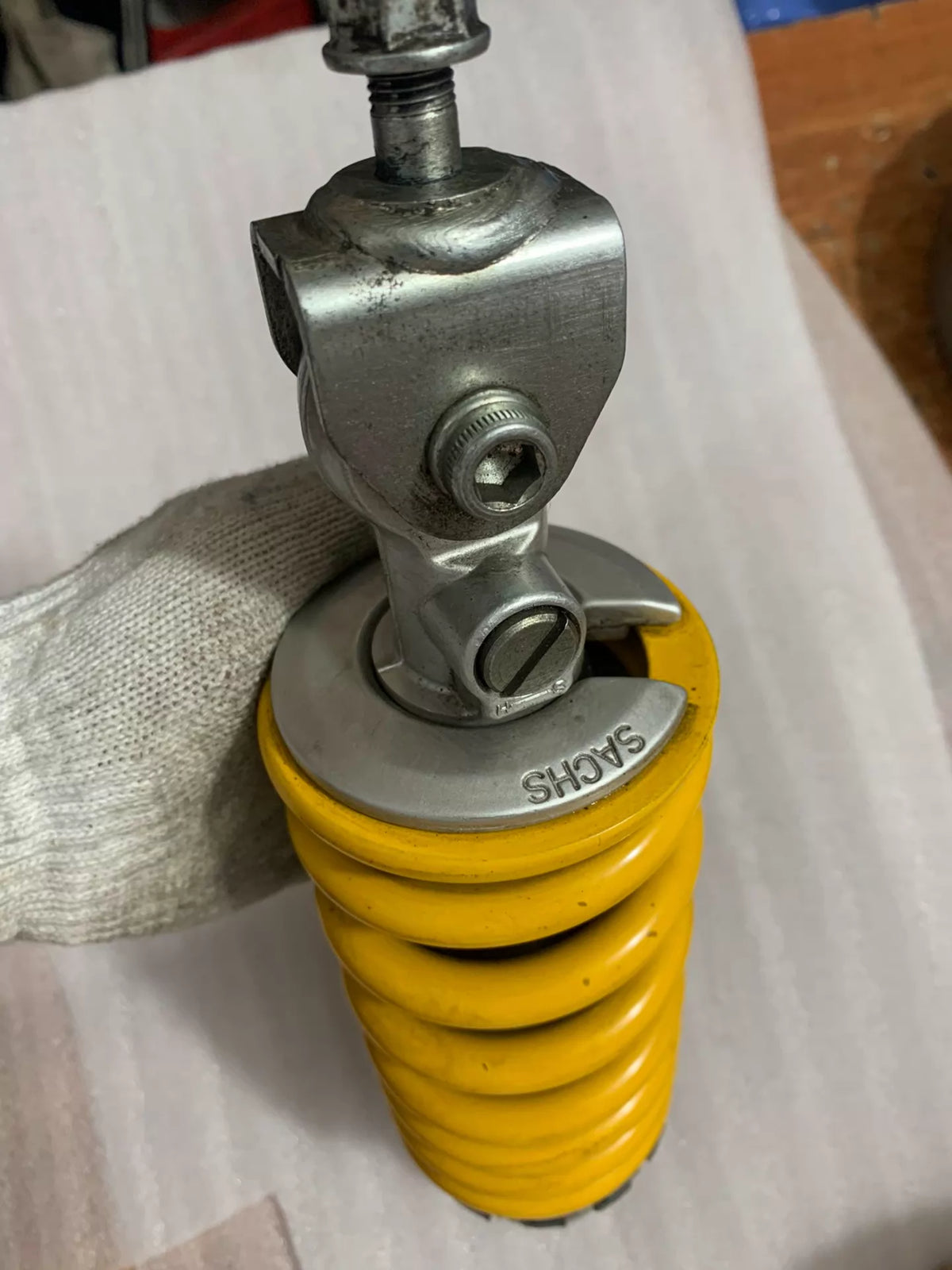 Ducati Monster 796 rear shock spring and damper body, angled view showing overall length