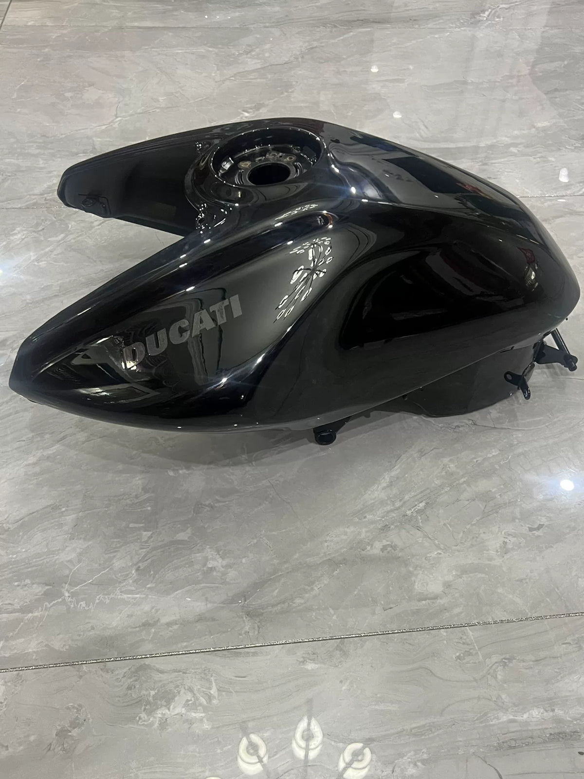 Ducati Diavel V4 black fuel tank close-up showing surface quality and logo area detail