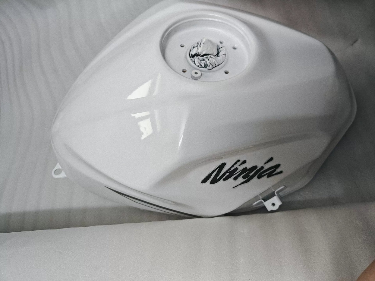 Kawasaki Ninja 400 white fuel tank three-quarter view showing overall shape and white paint finish