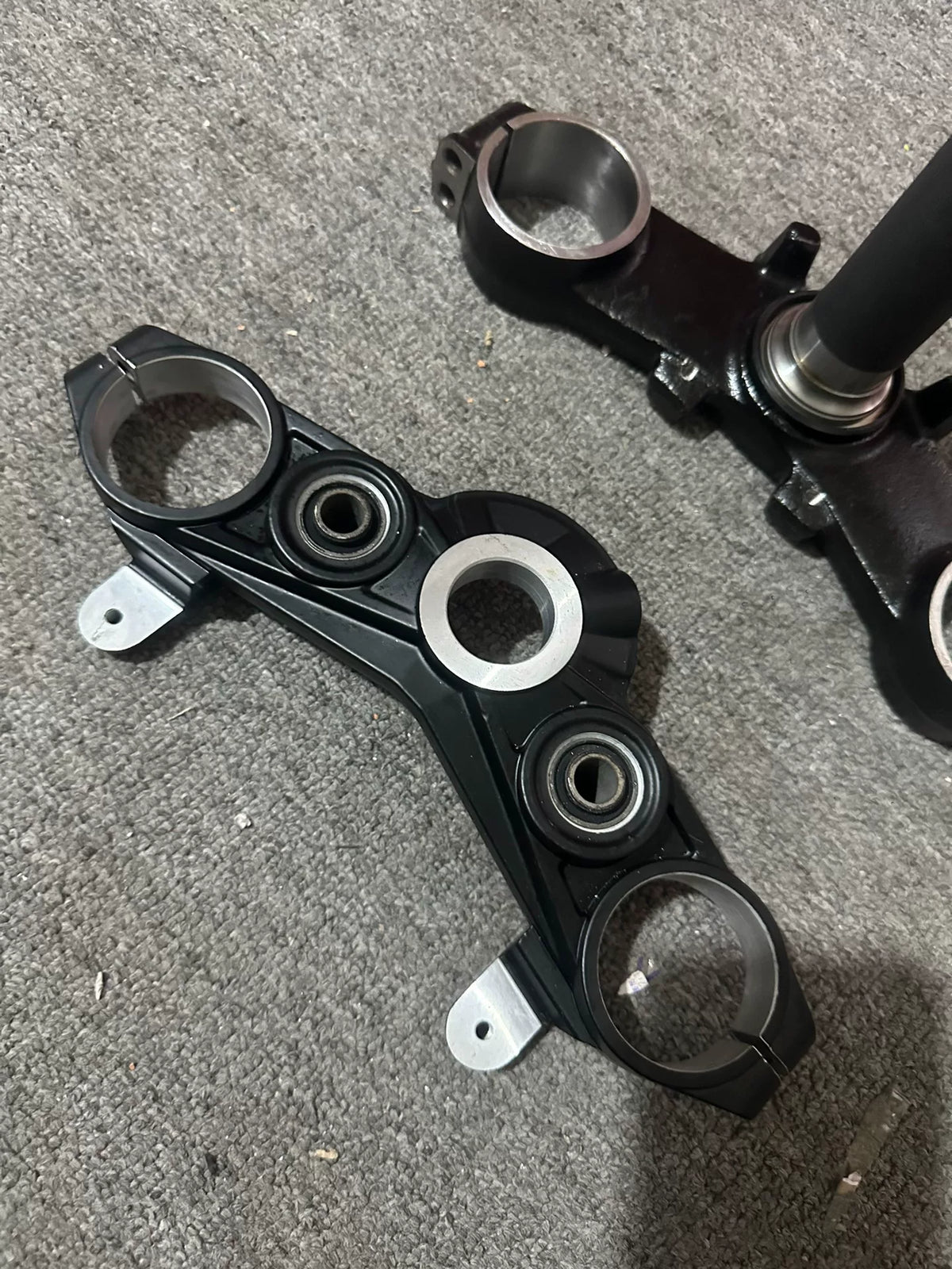 Kawasaki Z900 triple clamp bottom angle view showing stem and lower clamp mounting surface detail