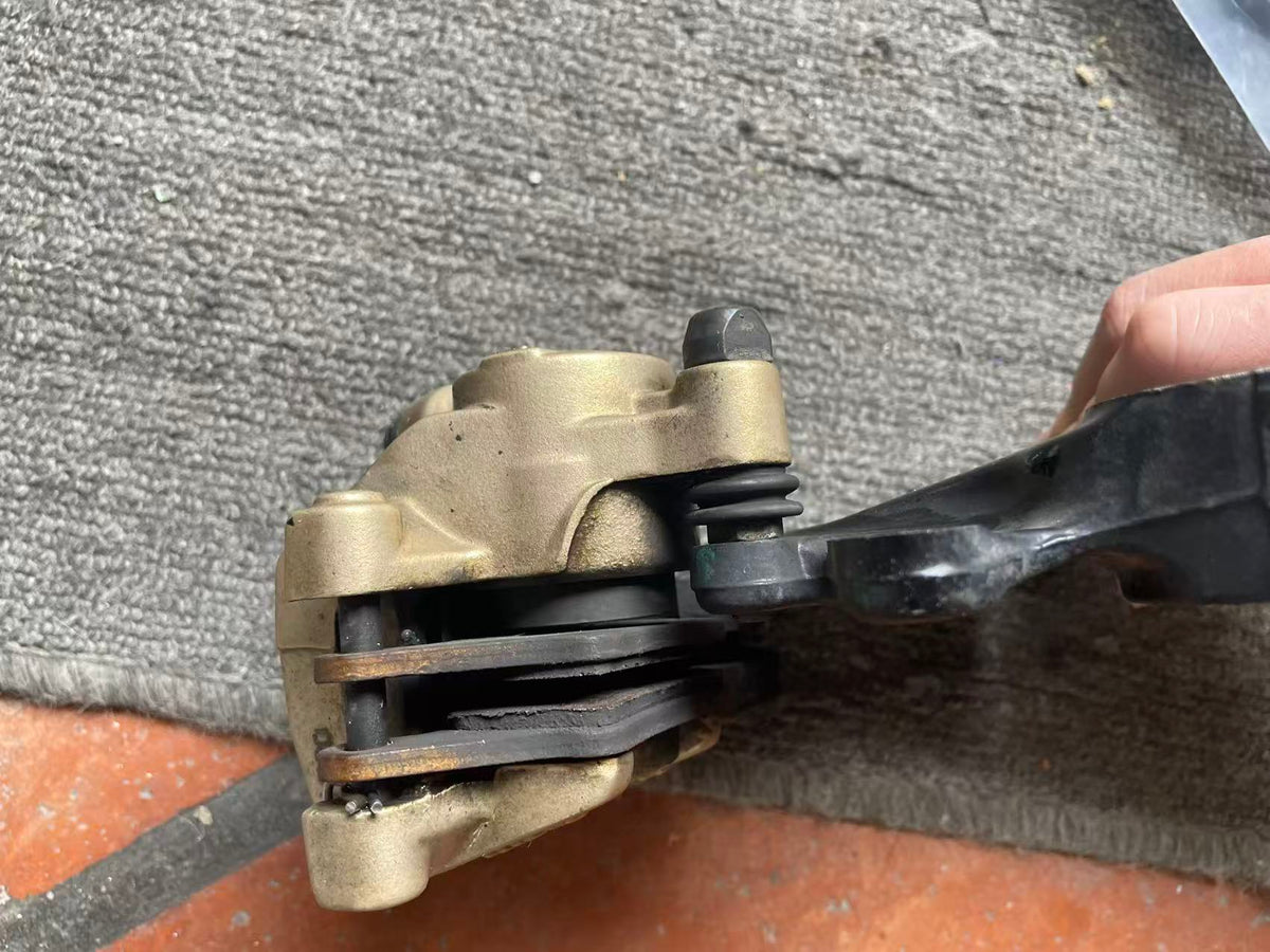 BMW G 310 R brake caliper top-down view highlighting bleed nipple and body casting