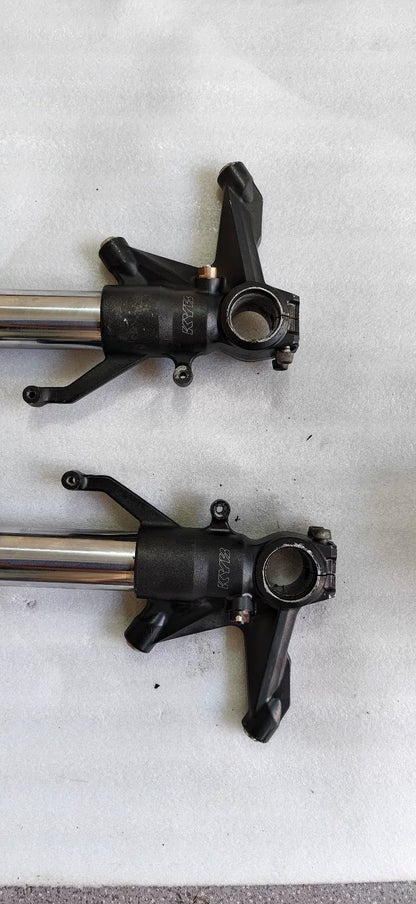 Kawasaki ZX-10R front fork lower leg close-up showing axle clamp and brake caliper mount