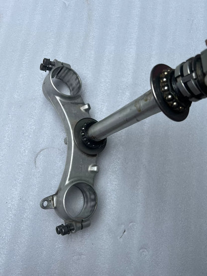 BMW S1000RR triple clamp close-up of fork tube clamp area showing pinch bolt slots and finish