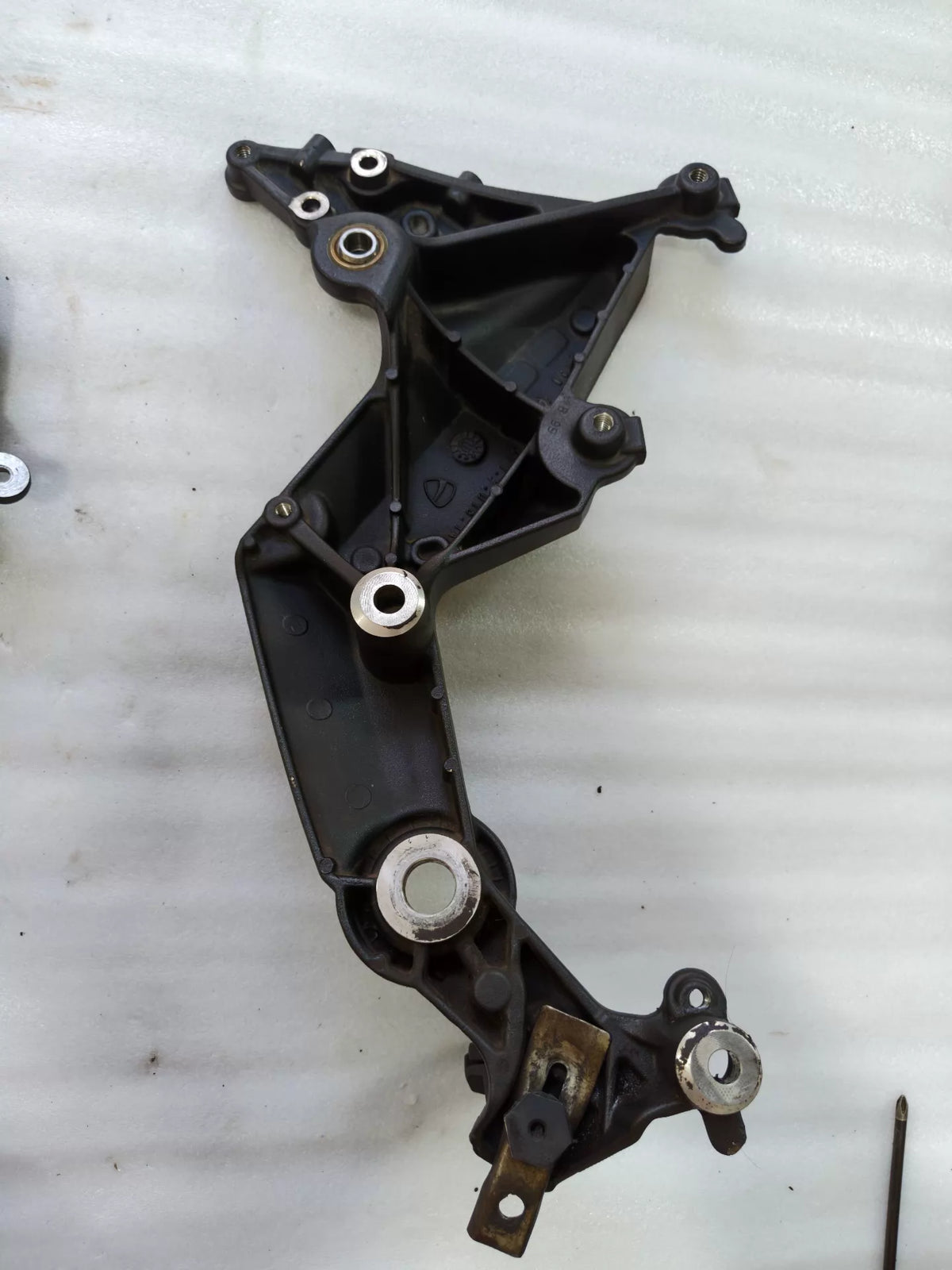 Ducati Multistrada 1200 footpeg bracket, side profile view showing bracket curvature and finish