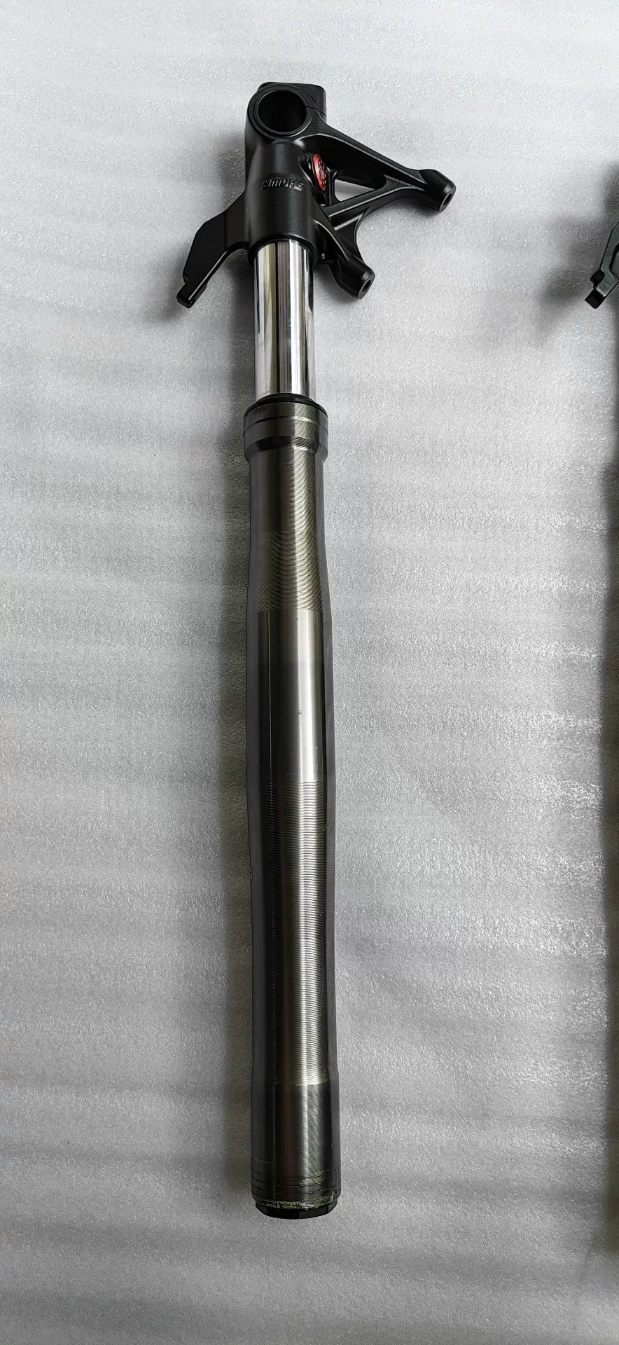 Ducati Panigale V2 front fork lower leg detail, brake caliper mount and axle clamp closeup