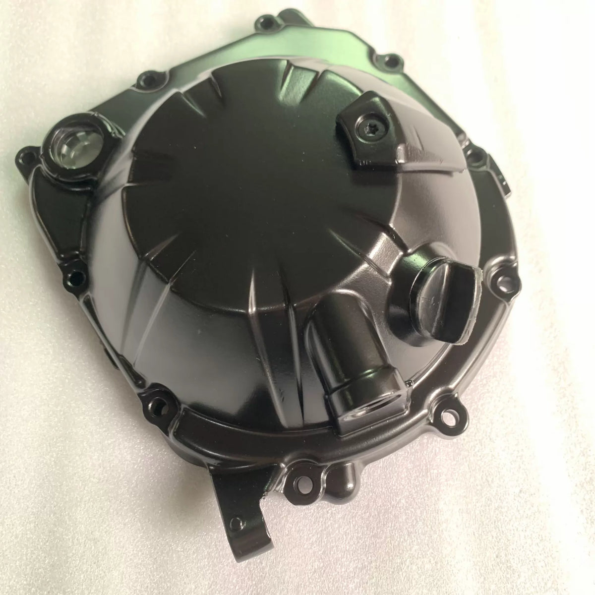 Black clutch cover for Kawasaki ZR900 Z900, top angled view showing oil sight glass and bolt bosses, clean finish