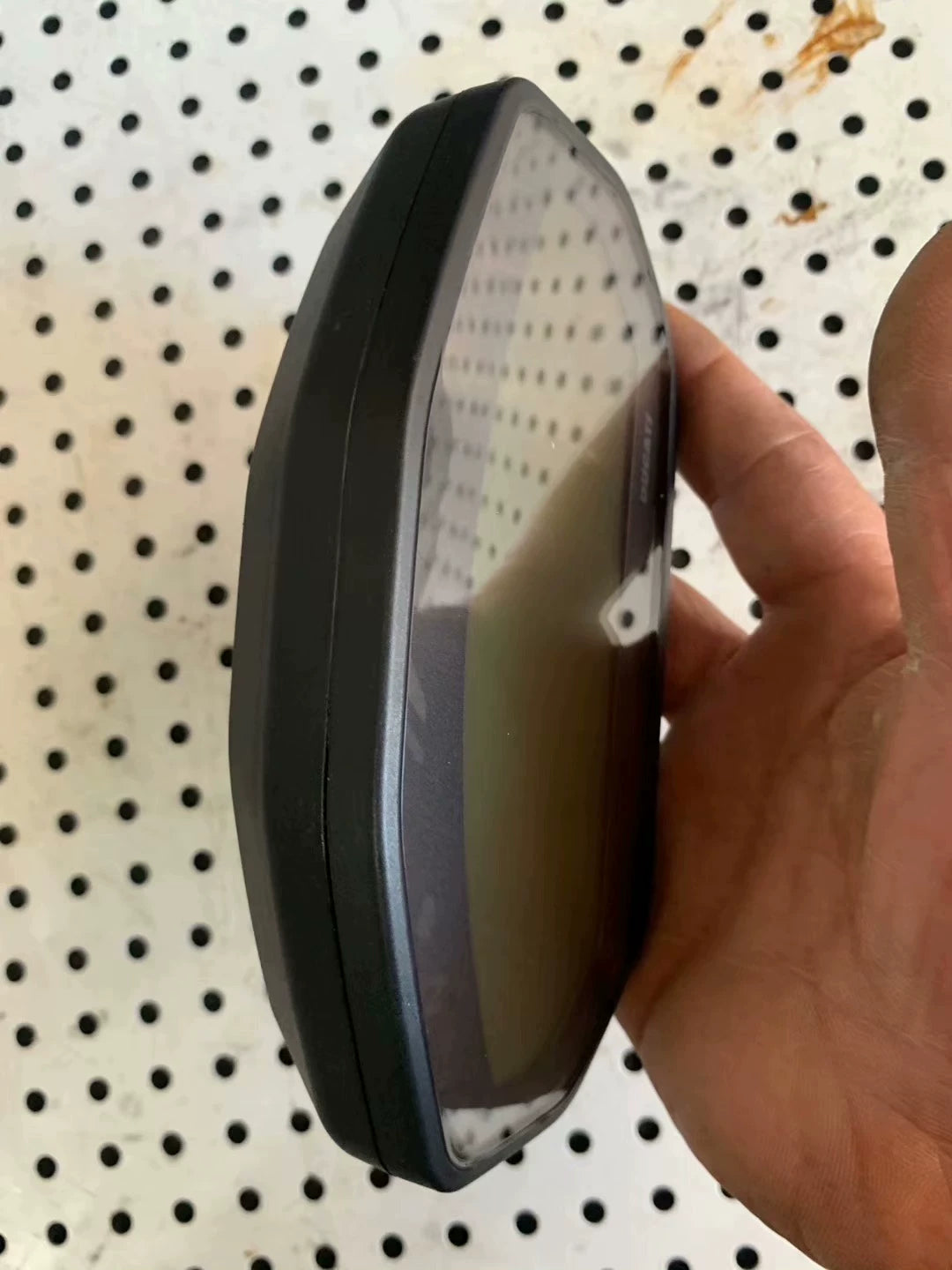 Side profile of Ducati Monster 797 instrument cluster, slim black housing and curved display glass