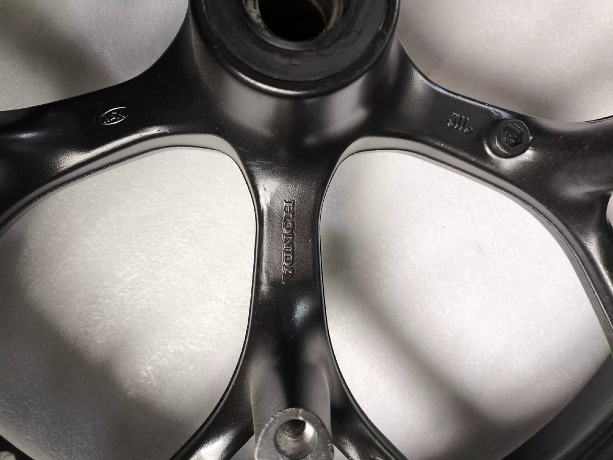 Black front wheel Honda NC750X three-quarter angle showing brake rotor mounting flange
