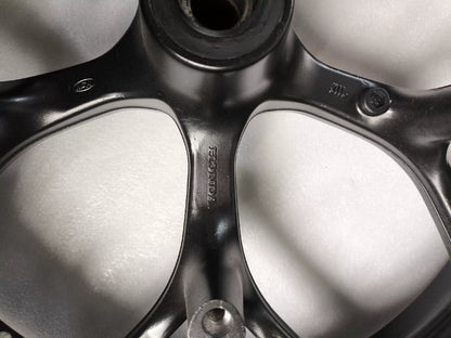 Black front wheel Honda NC750X three-quarter angle showing brake rotor mounting flange