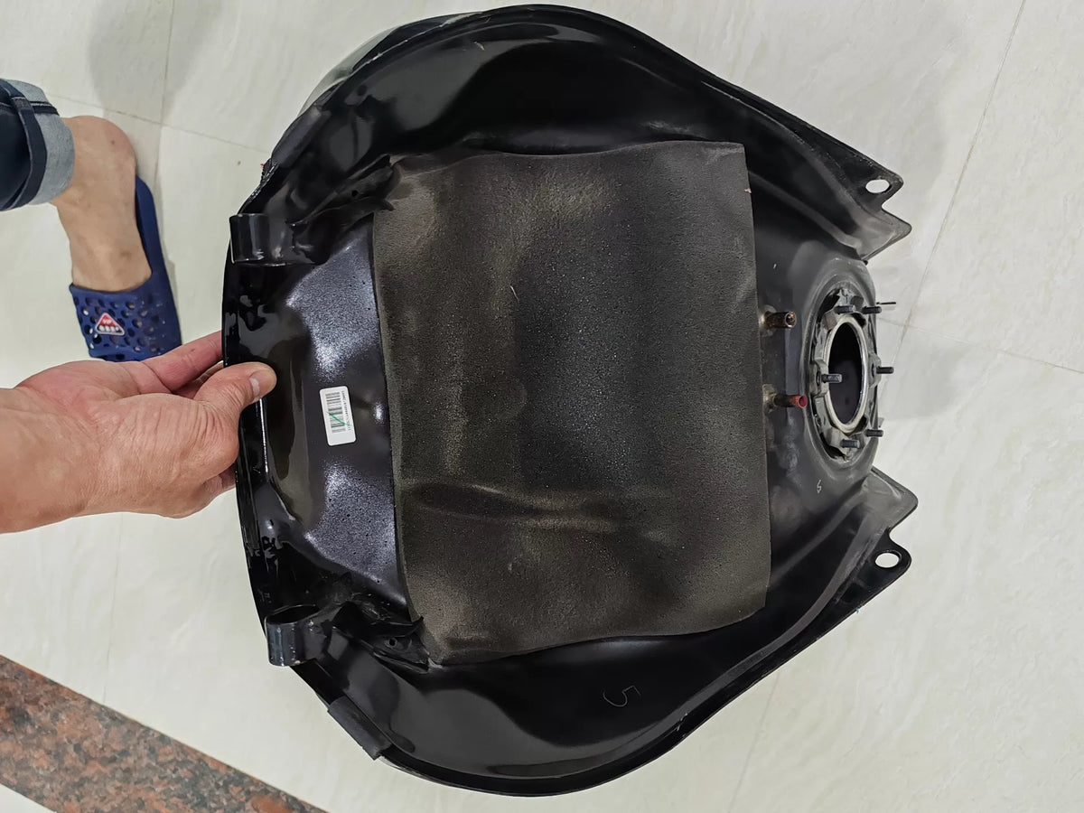 Honda CB650R fuel tank underside view displaying brackets and fittings
