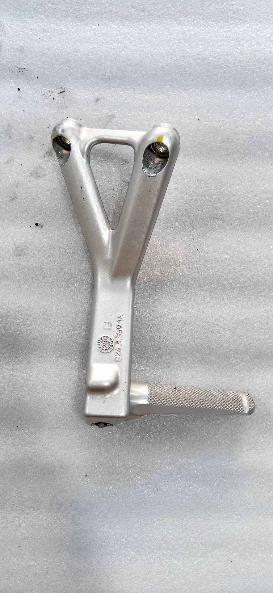 Panigale V4 rear sets bracket side profile view showing step adjustment positions and linkage mounting points