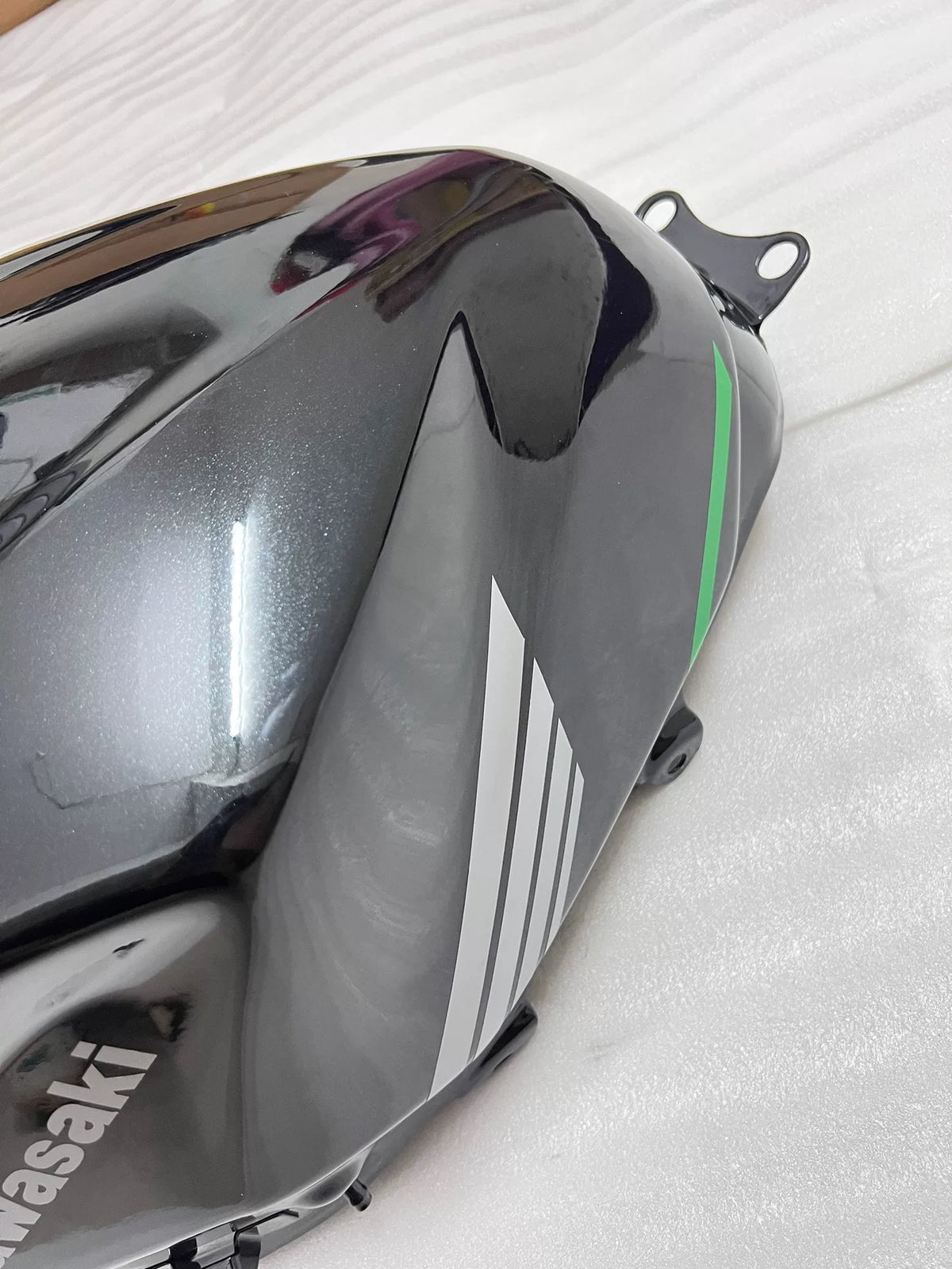 Kawasaki Ninja 400 fuel tank side profile view displaying smooth body lines and paint finish