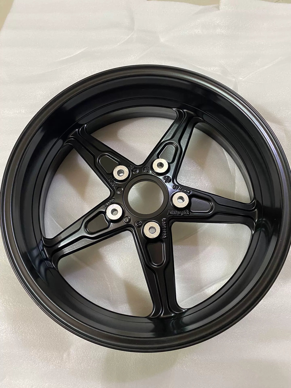 BMW R nineT front cast rim lateral view, full wheel profile with valve stem hole visible