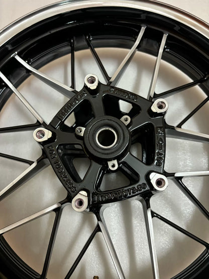 Kawasaki Z900RS front wheel assembly gloss black, angled side view showing rim and brake disc mount