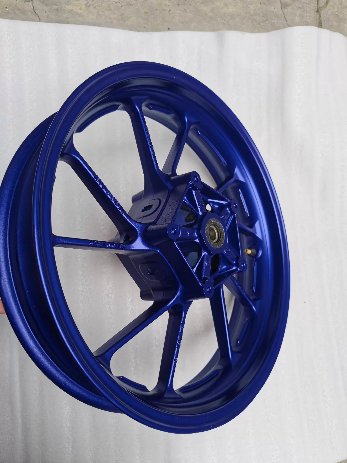 Side profile of blue cast front wheel for Yamaha MT-07 FZ-07, angled to show rim width and hub bearing