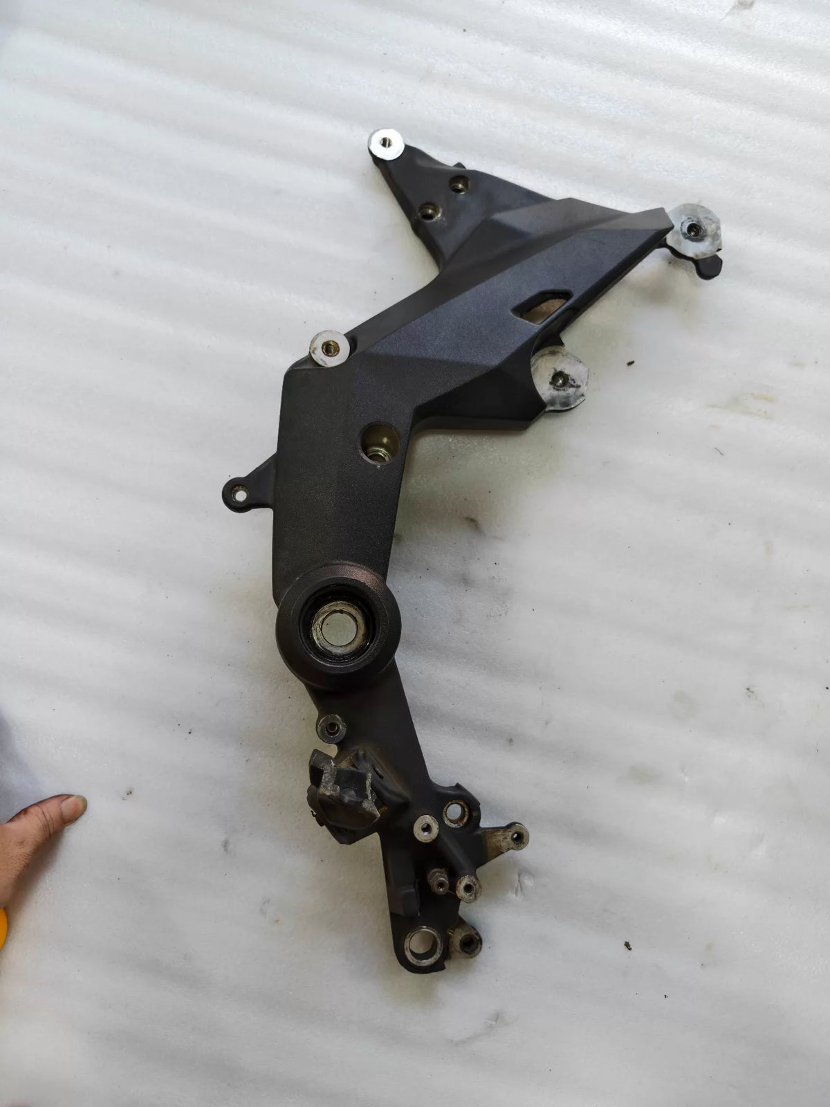 Ducati Multistrada 1200 footpeg bracket, top-down view revealing full bracket layout and bolt holes