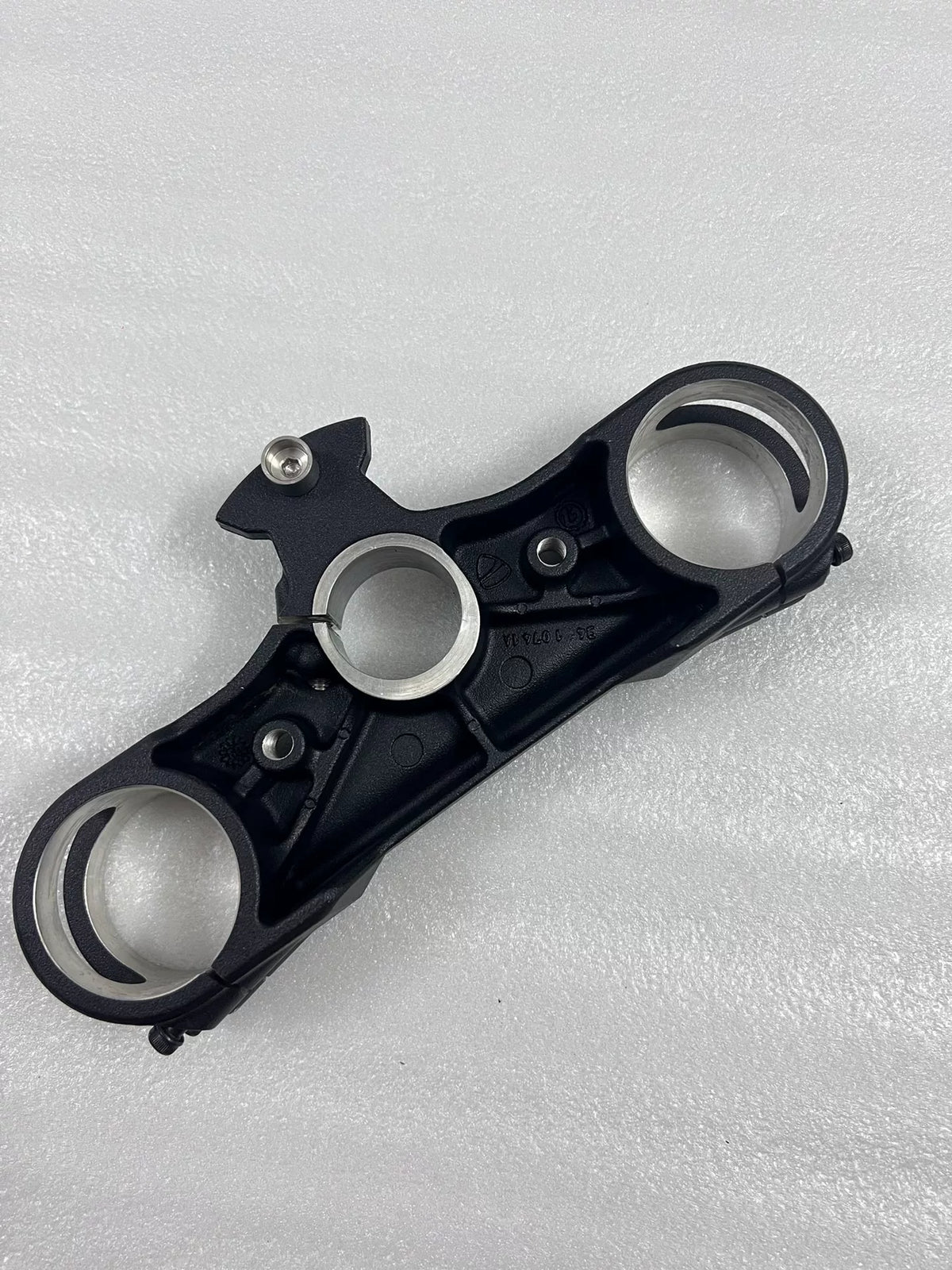 Lower fork yoke Ducati Multistrada 1200, top angle showing fork tube clamps and machined finish
