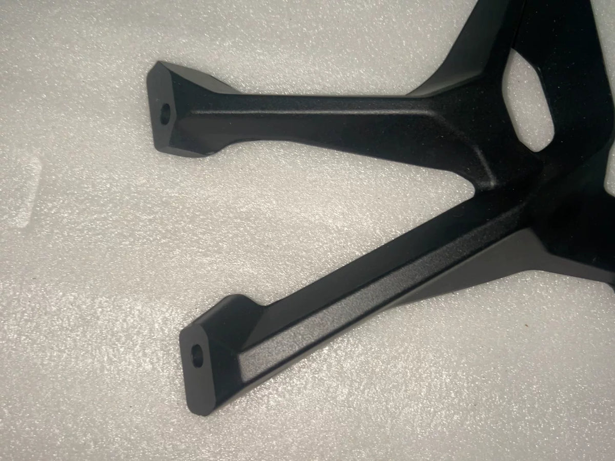 BMW S1000XR footpeg bracket, top-down view showing symmetrical bracket shape and surface finish