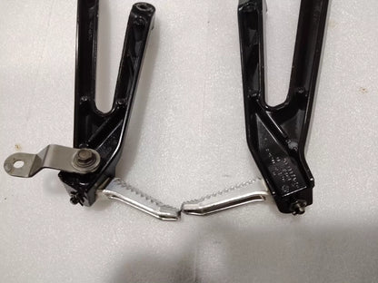 BMW S1000RR footpeg bracket, overhead flat lay view showing complete part dimensions and finish