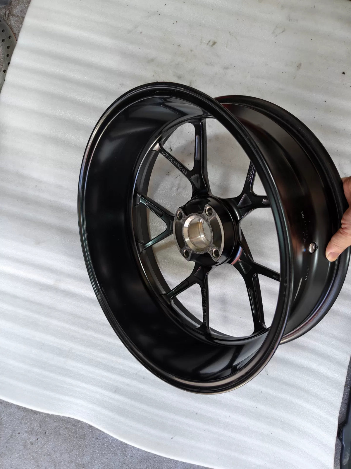 Ducati Panigale V2 rear wheel, angled view highlighting spoke pattern and rim edge condition